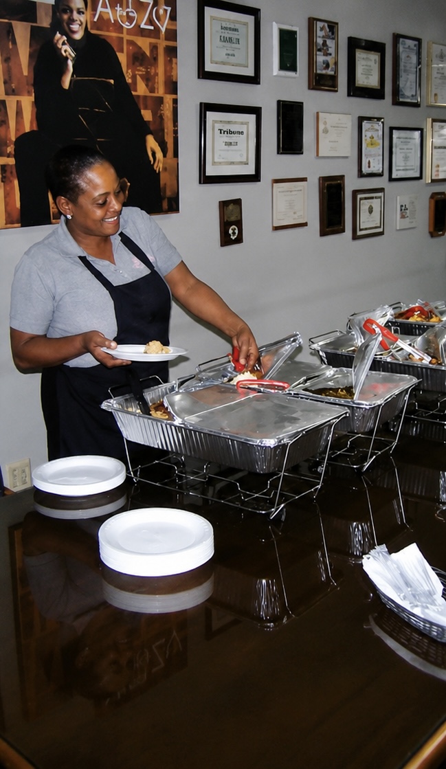 Chef Darlene Young serving guests from chafing trays at a Sistah's catered event