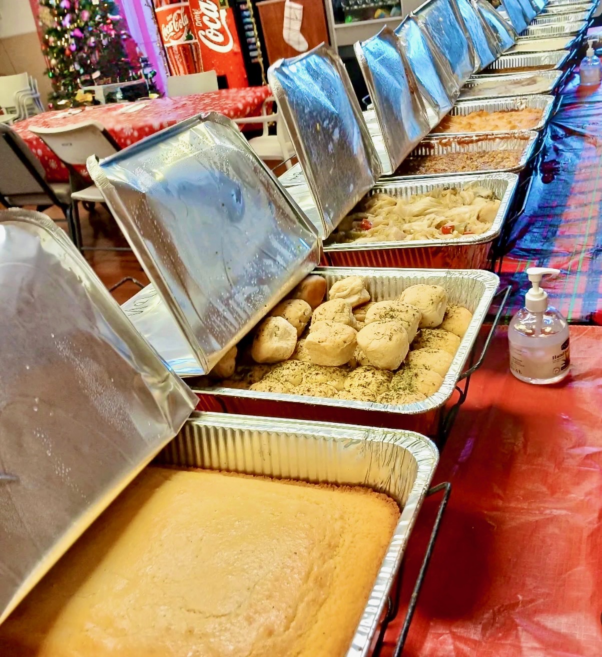 Memorial repast buffet line with chafing dishes of soul food served by Sistah's