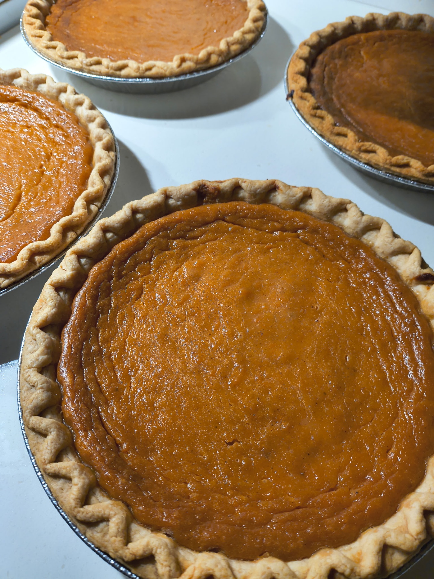 Freshly baked sweet potato pies with hand-crimped crusts